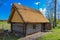 Old wooden sauna log cabin with thatched roof. Hiiumaa island, E