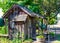 Old Wooden Shack With Flower Barrels