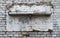 An old wooden shelf clings to an aged white brick wall, its paint peeling to reveal layers of history.