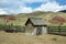 Old wooden shelter and tractor wheels