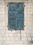 Old wooden shutters of blue color with peeling paint. Minimal style.