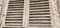 Old wooden shutters on the window. Antique wooden architecture. Dry wood with rustling discolored paint. Husk and dust. Natural