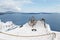 An old wooden spinning lathe above blue ocean in Santorini