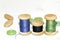 Old wooden spools of blue, green and black threads and buttons