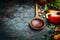 Old wooden spoon and fresh vegetables for tasty vegan cooking on rustic background, close up