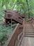 Old wooden stairway in forest, nature trail in reserve.