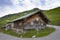 Old wooden and stone house in austrian mountains with deer antlers