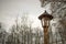 Old wooden street lamp outside in park village closeup electricity