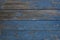 Old wooden surface with exfoliating paint dark blue colour 1