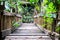 Old wooden suspension bridge used to cross the stream. The trees