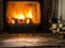 Old wooden table and fireplace with warm fire.