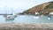 Old wooden table top with bay and boat background at Friendly bay, Oamaru, New Zealand.