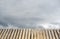 Old wooden table for a total blurred background the sky with clouds.