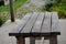 Old wooden table under the pergola. garden house, country style. Unpainted oak planks serve as a hiding place in the mountains fro