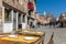 Old wooden tables in cozy outdoor cafe in Venice