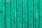 The old wooden tacky green background with vertical planks.