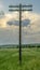 Old wooden Telegraph pole with cut electrical wires on sunset background