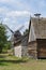 Old wooden traditional Polish windmill, barn and a house in the countryside