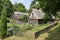 Old wooden traditional Polish wooden village houses with flower garden in the countryside