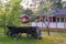 old wooden trailer cart at a countryside yard under the trees near swedish house scandinavian style