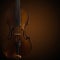 Old wooden violin on dark brown