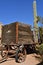 Old wooden wagon and trailer by a cactus tree