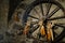 Old wooden wagon wheel with corn decoration - Old mill in the small village of Breno - Brescia - Lombardy - Italy