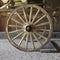 Old wooden wagon wheel on a wagon