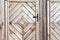 Old wooden wall texture or background with copy space. boards diagonally in a diamond shape. Detail of the door.