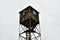 Old wooden watchtower against the cloudy sky