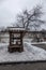 Old wooden well. Beautiful architecture. Snowy cloudy day.