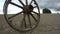 Old wooden wheel in clay soil field, time lapse 4K