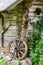 Old wooden wheel in village near old wooden house in Lithuania Europe