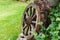 Old wooden wheel in willage near old wodden house