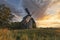 Old wooden windmill at dramatic sunset, historic outdoor background
