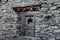 Old wooden window set into a historic stone building in Nepal