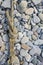 old worn battered marine rope on the pebble beach on a Sunny summer day