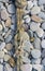 old worn battered marine rope on the pebble beach on a Sunny summer day