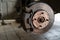 Old worn brake discs on a passenger car. Car on a lift in a car service