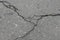 Old worn and cracked asphalt with cracks. Asphalt pavement road was damaged