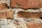 Old Worn Down Brick Wall with Plaster. Grunge Red Stonewall Background, Texture. Shabby Building Facade With Damaged Plaster.