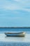 Old worn fishing dinghy boat moored at the coast of Kattegat sea near Halmstad