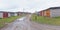 Old worn garageboxes with colorful doors along a dirtroad in Paldiski