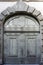 Old worn grey door of an old Renaissance palazzo in the center of Florence, Italy