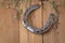 An old worn horseshoe with studs and dry grass blades. .