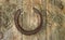 Old worn horseshoes on the background of old wooden planks.