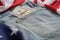 Old worn jeans are lying on flag United States America and there are hundred dollar bills in pocket