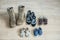 Old worn military boots, women`s shoes and lot of baby shoes on wooden floor. Top view