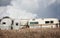 Old worn out camper trailers sitting in the junk yard.