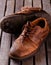 Old worn shoes on grey wooden board